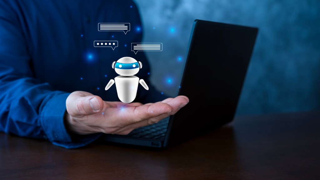 Person holding out a hand beside a laptop with a floating chatbot icon and speech bubbles, representing an AI teammate assisting with live sales calls and follow-up.